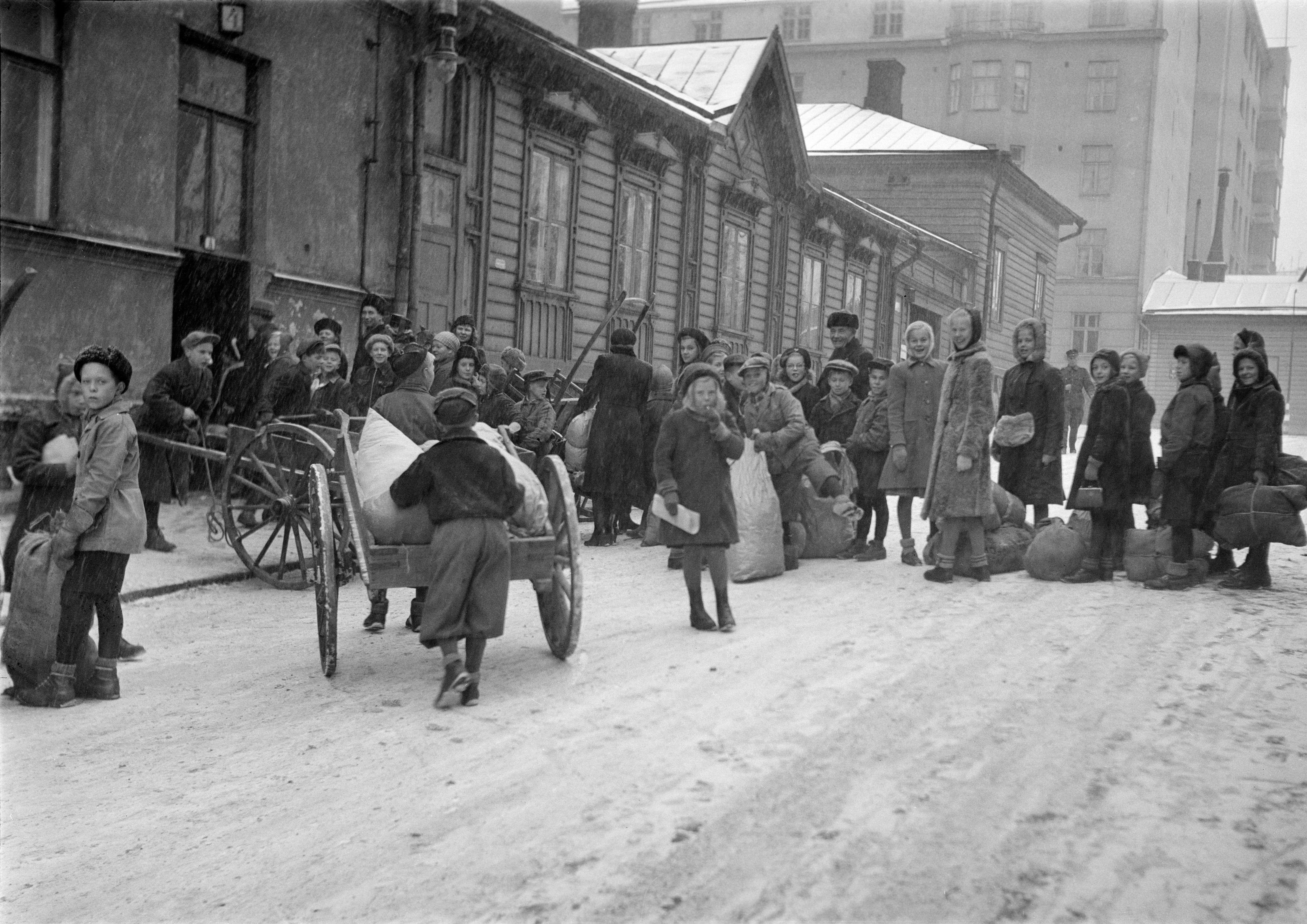 Koululaiset ottavat osaa sotaponnistuksiin keräämällä lumppuja tekstiiliteollisuuden raaka-aineeksi. 1941. Uuden Suomen kokoelma, Suomen valokuvataiteen museo.