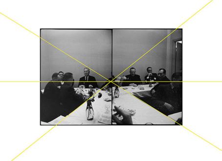 Niina Vatanen, sarjasta / från serien / from the series Archival Studies/Portrait of an Invisible Woman (2014) Vierekkäin kaksi mustavalkoista kuvaa, joissa istuu miehiä pöydän ääressä. Kuvien läpi on vedetty suoria keltaisia viivoja, jotka kohtaavat suunnilleen kuvien keskellä.