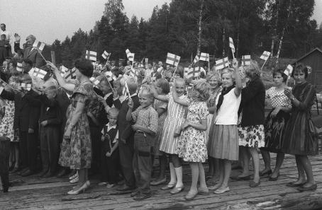 Matkustaja-alus Saimaa saapuu laituriin, lapset heiluttavat pienoislippuja. (Viikkosanomat 1961). Kalle Kultala, Savonlinna, 1961. Suomen valokuvataiteen museo.